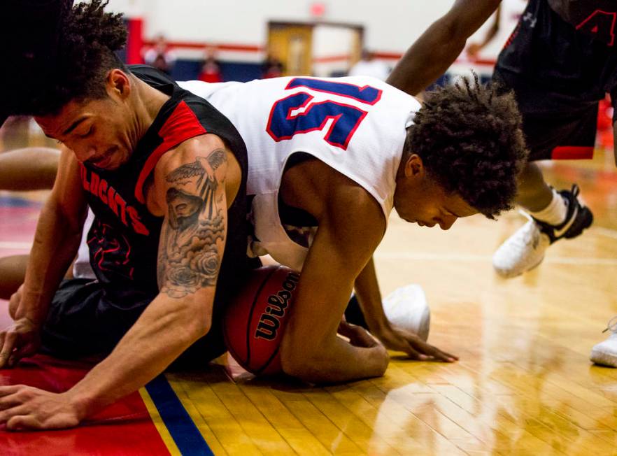 Liberty’s Cameron Burist (15) and Las Vegas’ Donovan Joyner (12) grapple over th ...