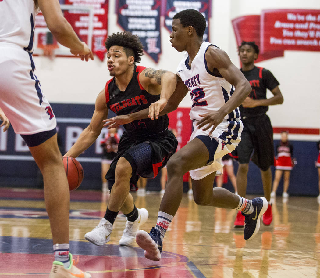 Las Vegas’ Donovan Joyner (12) attempts to dribble around Liberty’s Jordan Wafer ...