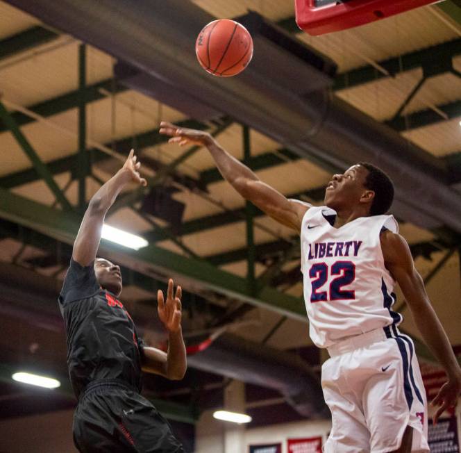 Las Vegas’ KJ Johnson (3) throws toward the hoop while Liberty’s Jordan Wafer (2 ...