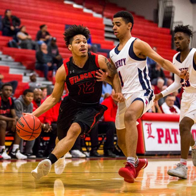 Las Vegas’ Donovan Joyner (12) attempts to dribble around Liberty’s Kobe Strough ...