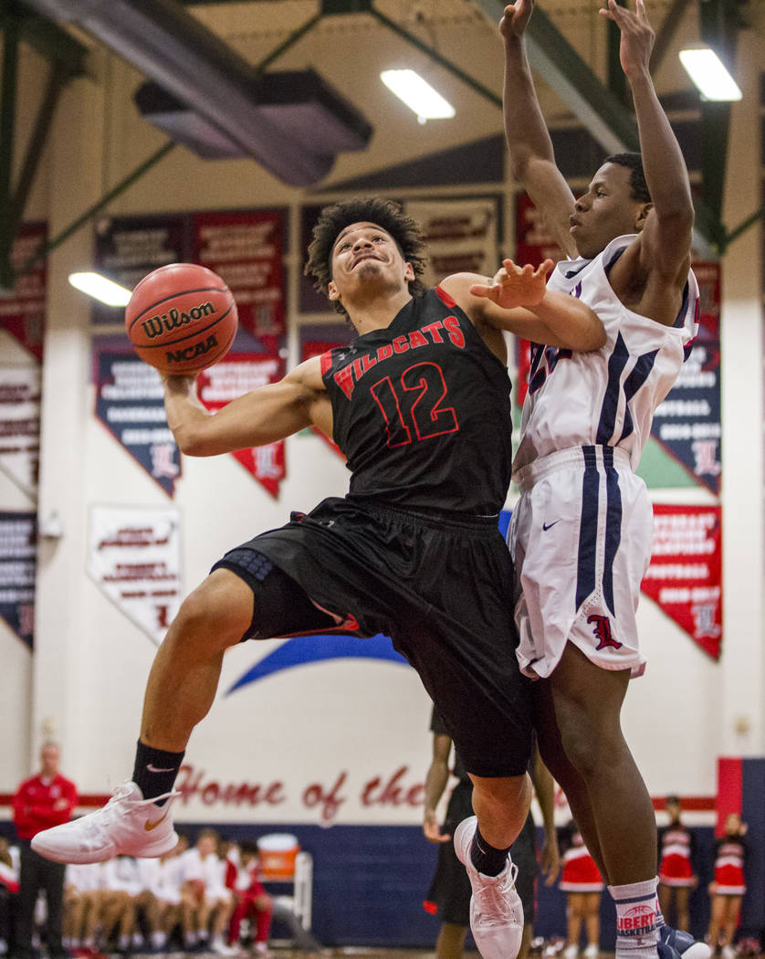 Las Vegas’ Donovan Joyner (12) attempts to dribble around Liberty’s Jordan Wafer ...