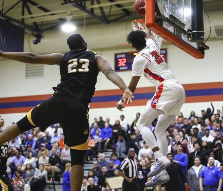 Bishop Gorman’s Jamal Bey (35) attempts a dunk past Clark’s Antwon Jackson (23) ...