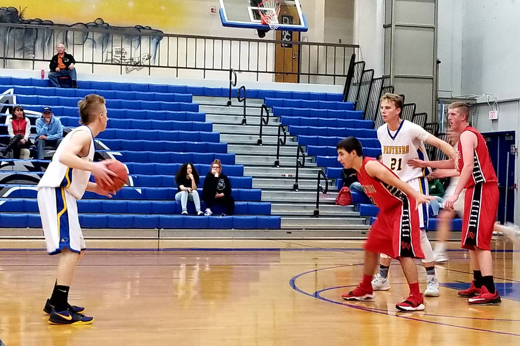 Pahranagat Valley’s Brodey Maxwell, left, handles the ball while teammate Culen Highbe ...