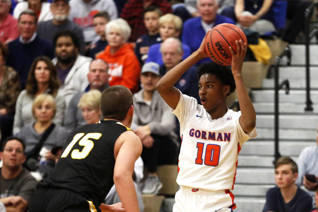 Bishop Gorman’s Zaon Collins (10) shoots against Clark’s James Bridges (15) duri ...