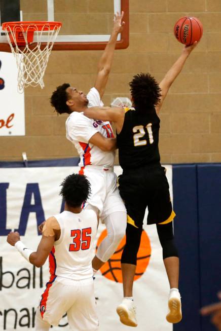 Bishop Gorman’s Jamal Bey (35) defends against Clark’s Jalen Hill (21) during th ...