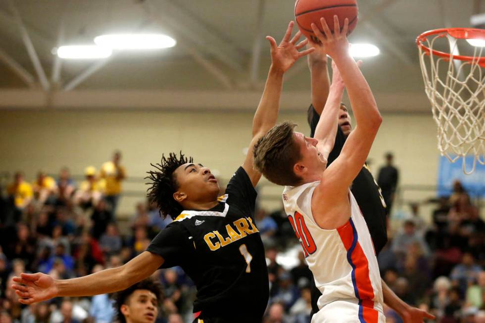 Bishop Gorman’s Noah Taitz (20) shoots against Clark’s Frankie Collins (1) duri ...