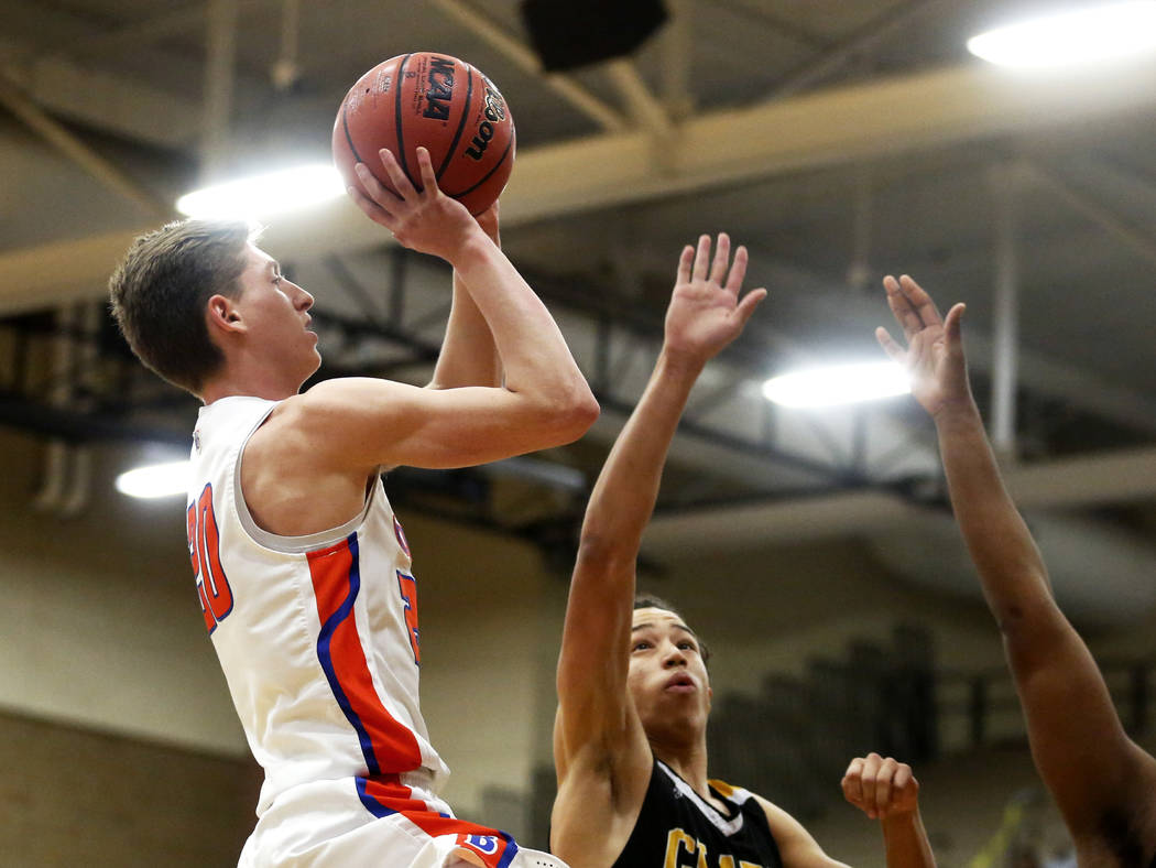 Bishop Gorman’s Noah Taitz (20) shoots against Clark’s Ian Alexander (32) durin ...