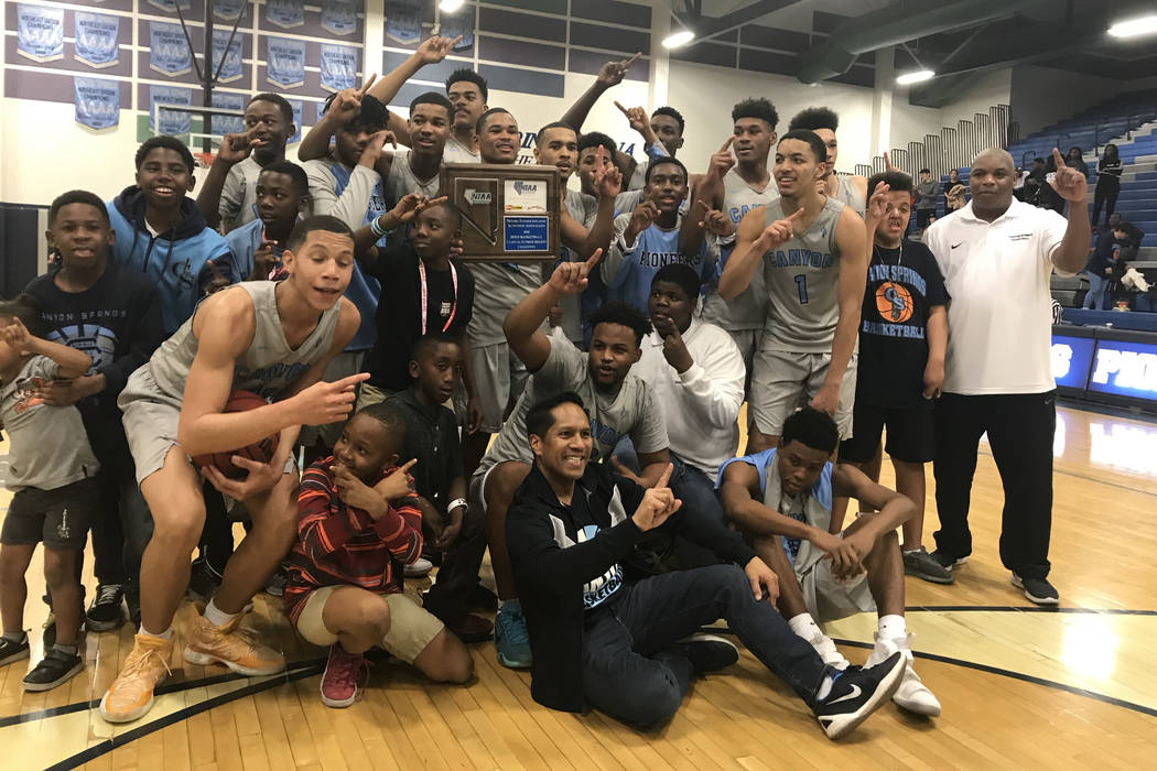 Canyon Springs players pose with the trophy after beating Coronado for the Class 4A Sunrise ...