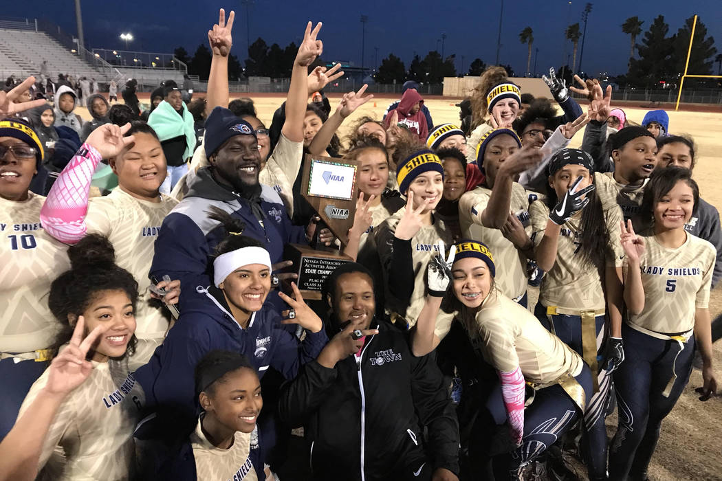 Cheyenne players and coaches pose with the Class 3A state flag football championship trophy ...