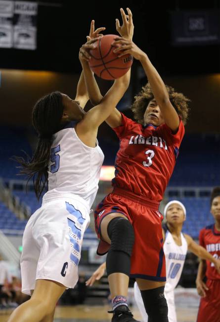 Centennial’s Jade Thomas fights for the ball with Liberty’s Journie Augmon durin ...