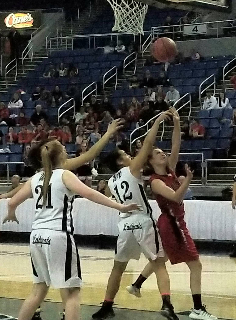 Lincoln County’s Kendra Mathews takes a shot over White Pine’s Evan Kingston dur ...