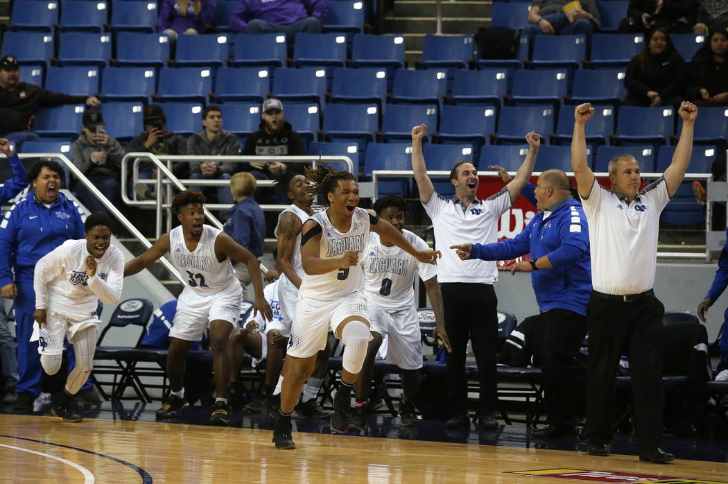 The Desert Pines team celebrates after defeating Cheyenne 48-44 in overtime for the NIAA 3A ...