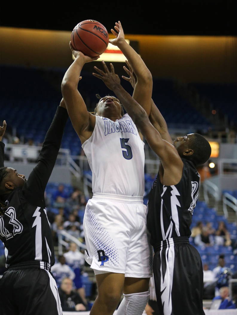 Desert Pines’ Lorenzo Brown shoots past Cheyenne defenders in nthe NIAA 3A state baske ...