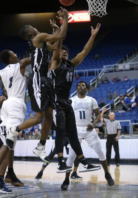 Desert Pines’ Dayshawn Wiley, left, and Darius Mitchell and Cheyenne’s Kavon Wil ...