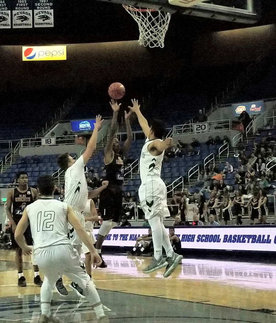 Democracy Prep’s Najeeb Muhammad shoots over two Battle Mountain defenders at Lawlor E ...