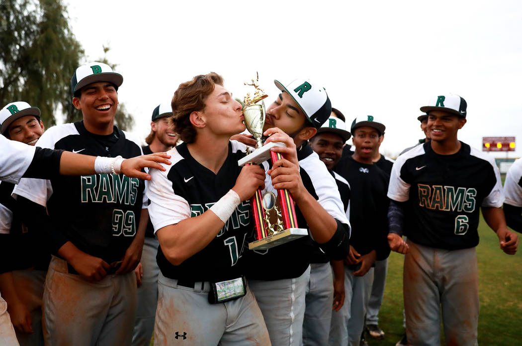 Rancho Rams’ Joseph Walls (14) and Carlos Hernandez (25) kiss the trophy after beating ...