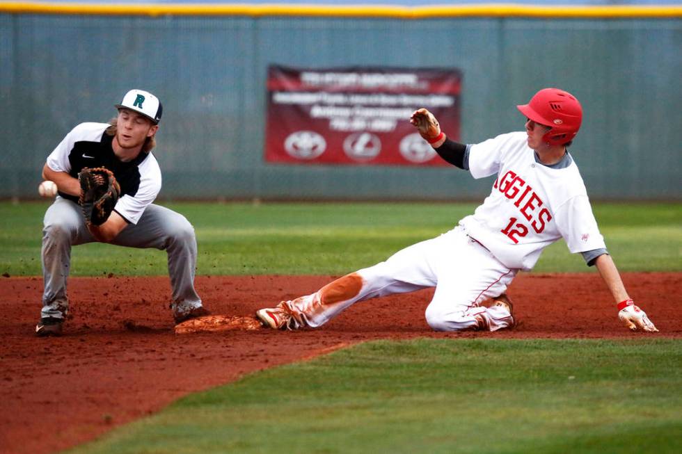 Arbor View Aggies’ Jesse Pierce (12) slides into second base during a game against the ...