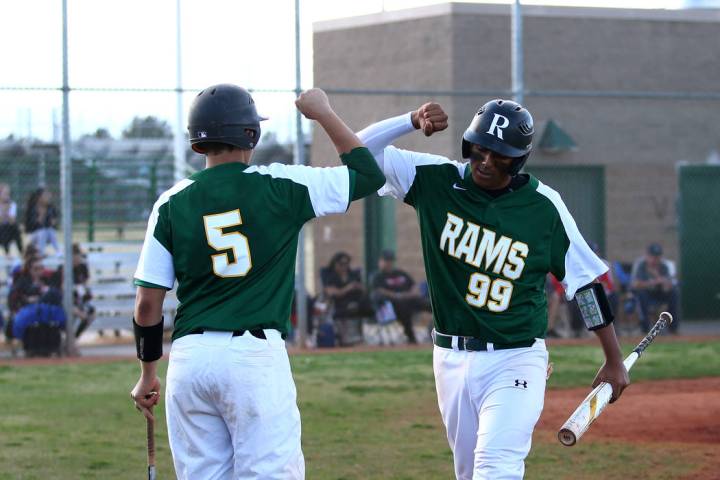 Rancho Rams’ Jimmy Gamboa (99) and Matthew Baughn (5) celebrate after a run scored aga ...