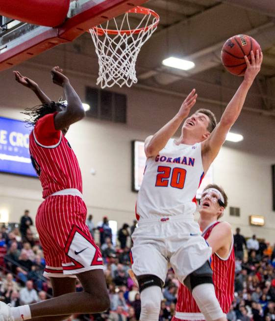 Bishop Gorman’s Noah Taitz (20) shoots while Findlay Prep’s Bol Bol (10) looks t ...