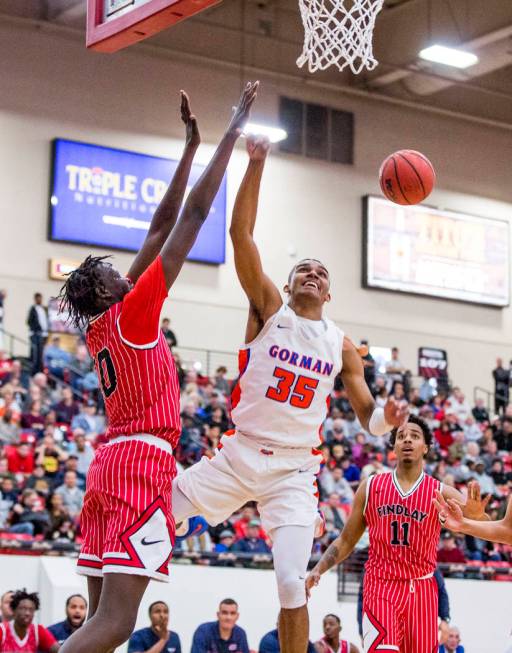 Bishop Gorman’s Jamal Bey (35) loses control of the ball against Findlay Prep’s ...