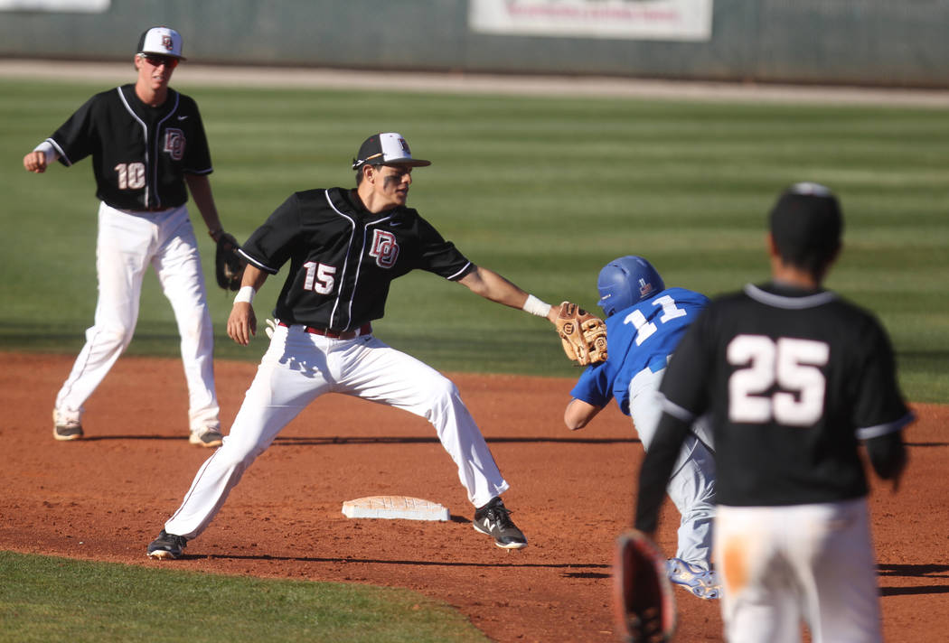 Desert Oasis second baseman Steven Giatti (15) tags out Green Valley baserunner Josh George ...