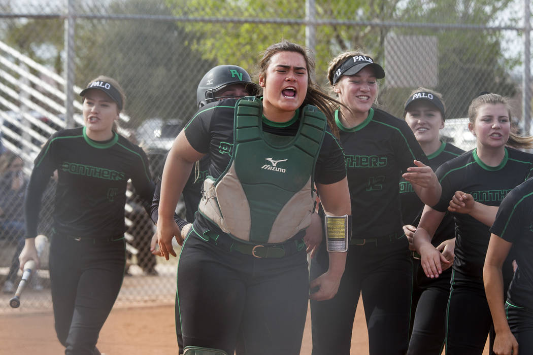 Palo Verde catcher Grace Chavez celebrates after Lauryn Barker scored a run during the third ...