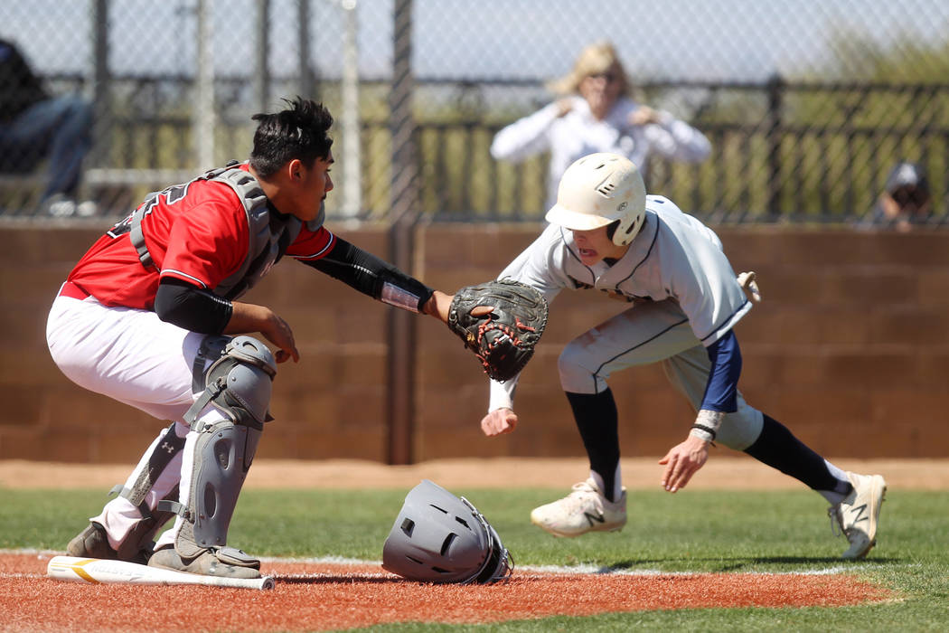 Las Vegas catcher Daniel Jimenez fields the throw as Rim of the World (Calif.) baserunner Co ...