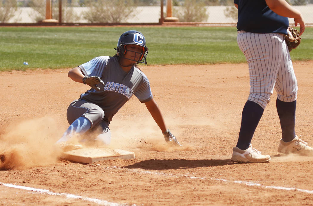 Centennial’s shortstop Kiana Tate (4) slides safely unto third base against North High ...