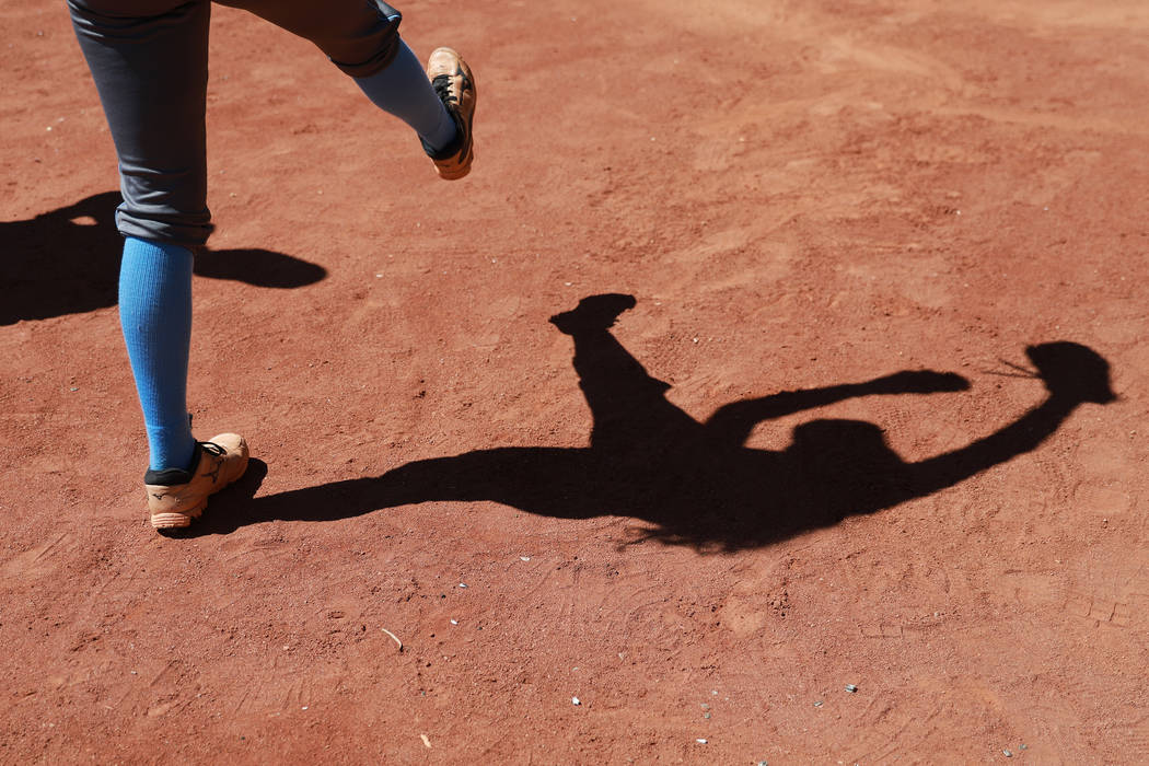 A Centennial softball player practicers her swings against North High School in the third in ...