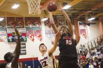 Liberty High School’s Cameron Burist (15) attempts a basket against Coronado High Scho ...