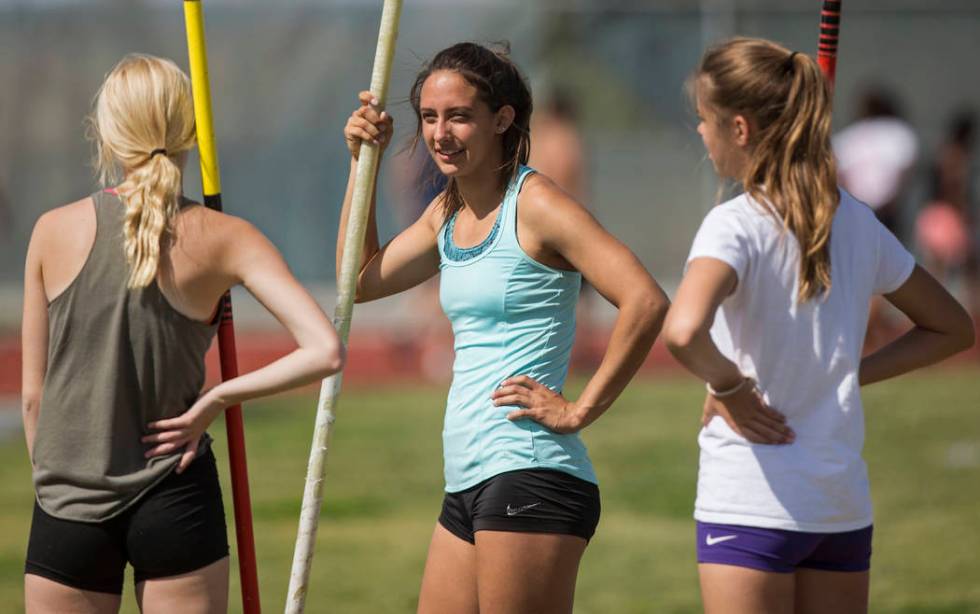 Gabby Carson, middle, one of Nevada’s top prep pole vaulters, talks with teammates dur ...