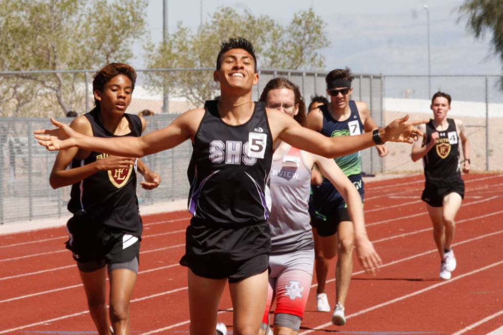 Silverado senior runner Omar Aguilar-Espinoza (5) celebrates his victory as crossing the fin ...