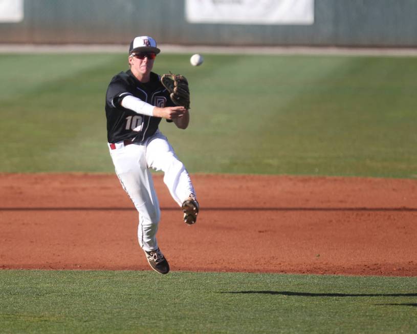 Desert Oasis shortstop Cole Schaefer throws to first during a game against Green Valley High ...