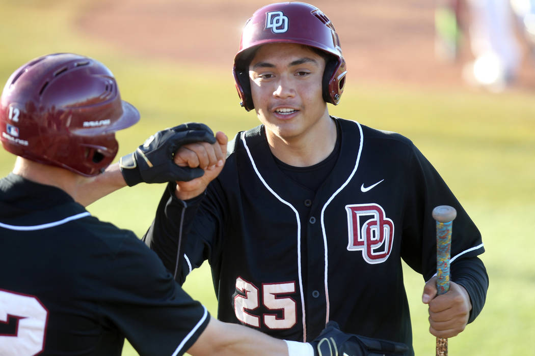 Desert Oasis’ Aaron Roberts (25) celebrates with Jason Sharman, left, after scoring ag ...