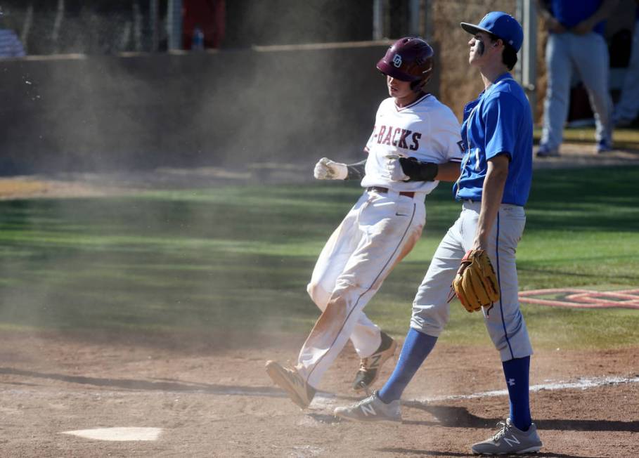 Desert Oasis baserunner Cole Schaefer (10) scores on a wild pitch as Bishop Gorman pitcher P ...