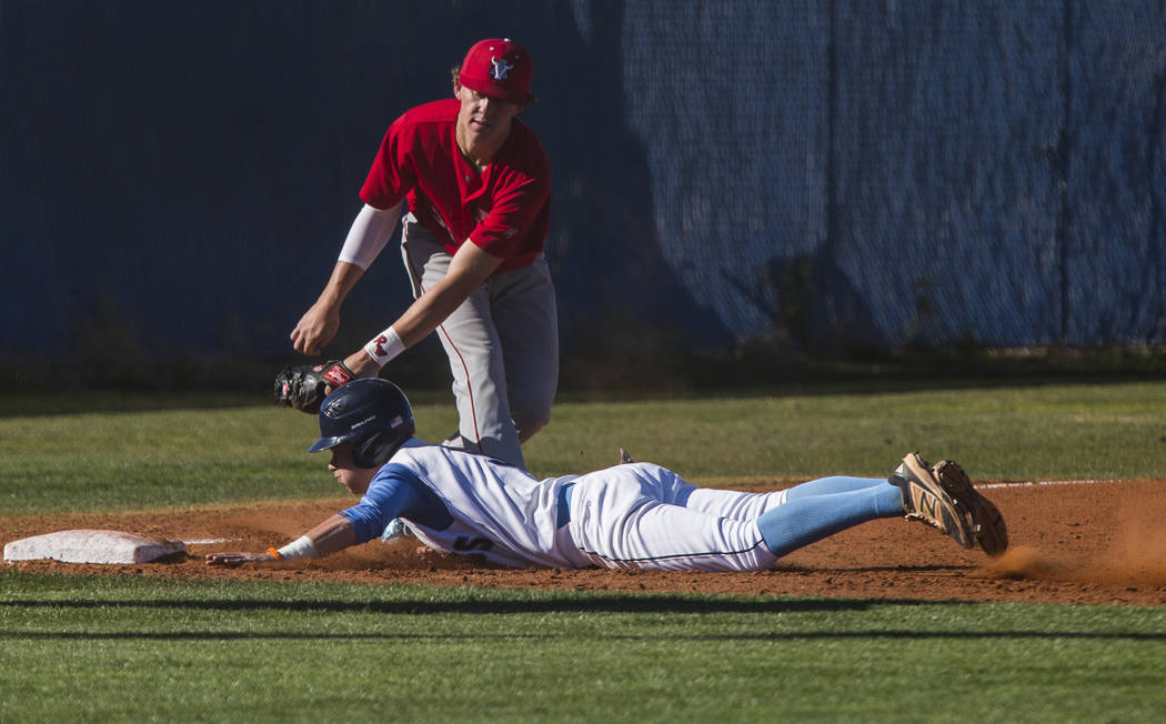 Arbor View infielder Austin Pfeifer tags Centennial’s Payton Moody out at third base d ...