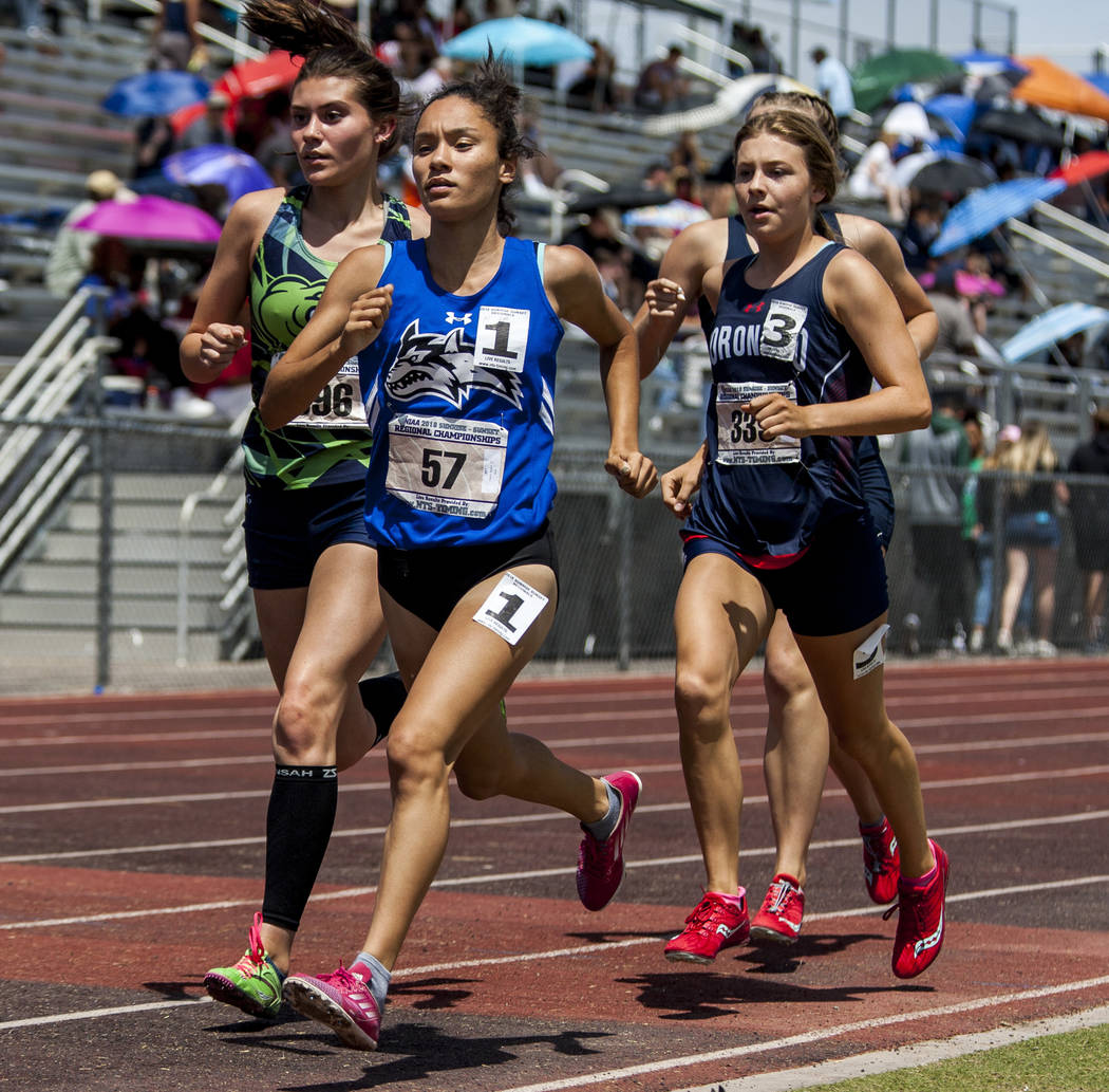 Basic junior Raquel Chavez, center, runs in the 1,600-meter run, finishing first with a time ...