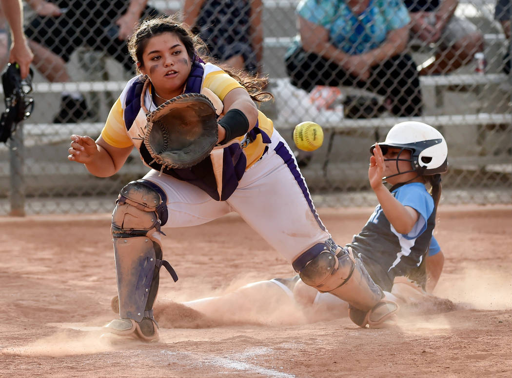 Durango catcher Alexis Geraldo looks to catch the ball as Durango’s Samantha Lawrence ...