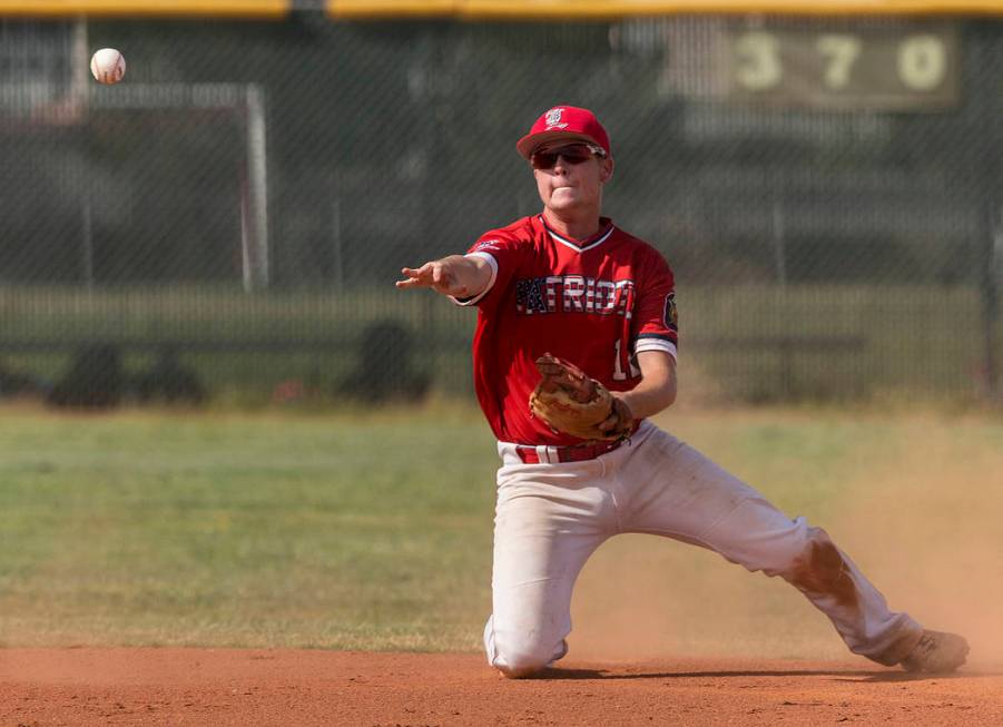 Liberty second baseman Tyler Williamson (12) makes a sliding stop in the first inning during ...