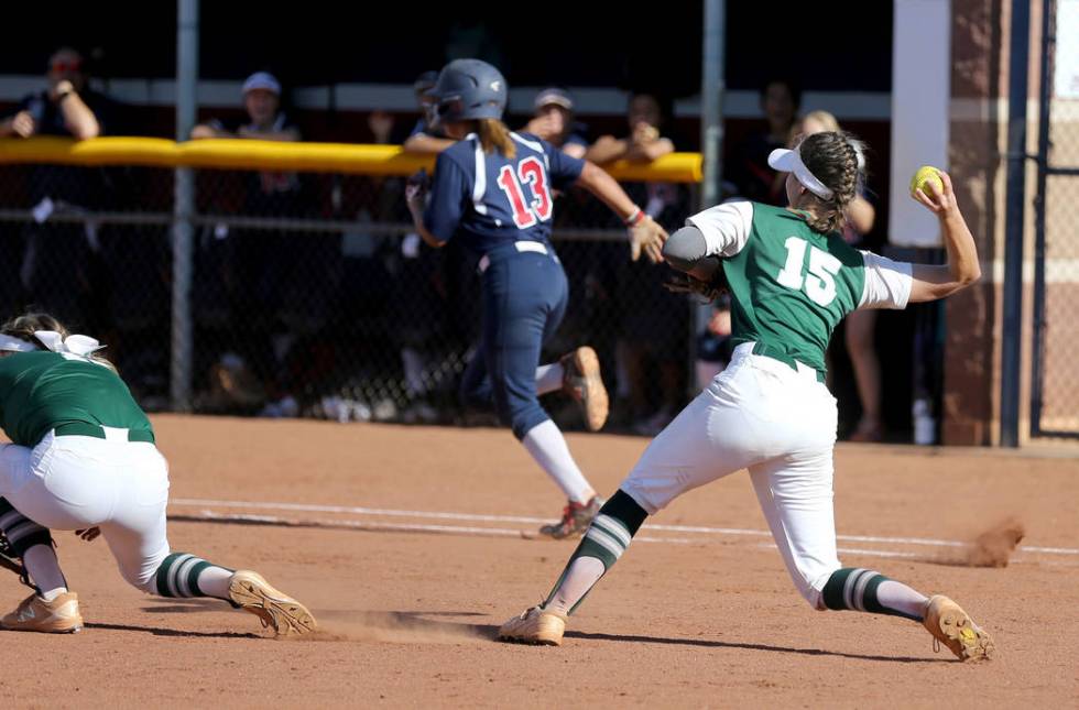 Green Valley Alicia Ortega (15) throws to first to get Coronado baserunner Sydney Smith (13) ...