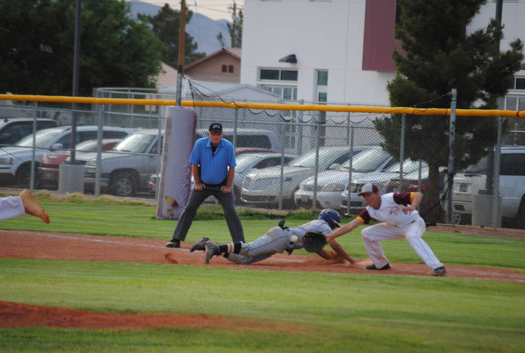 Boulder City’s Travis Hungerford dives safely back to first on Thursday, May 10, 2018. ...