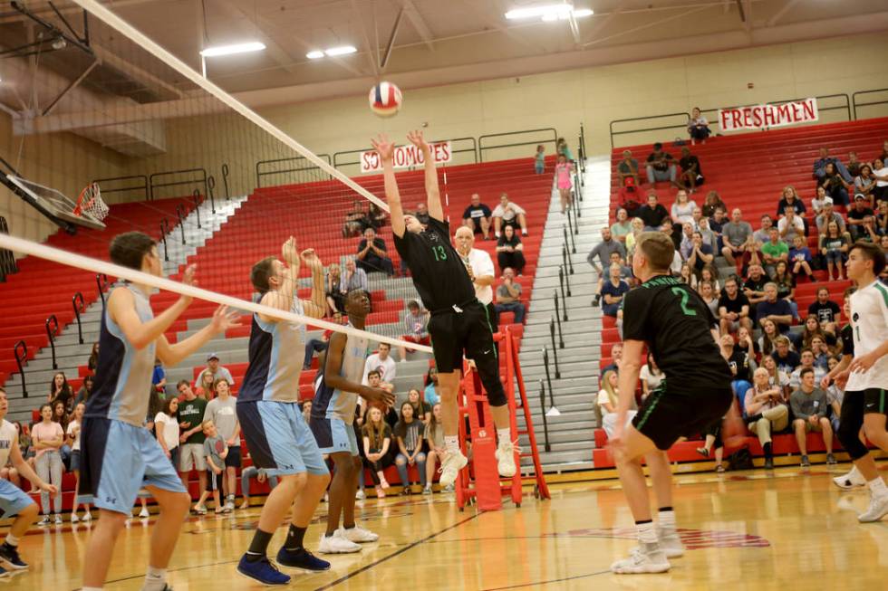 Palo Verde High School’s Luke Johnston (13) returns a shot against Centennial High Sch ...