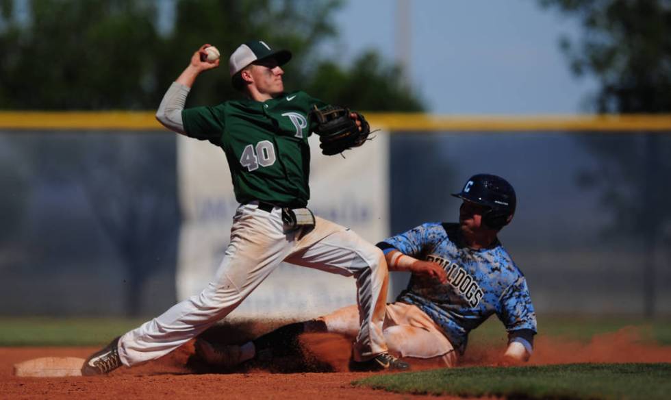 Palo Verde second baseman Nate Bartlett turns a double play as Centennial base runner Austin ...