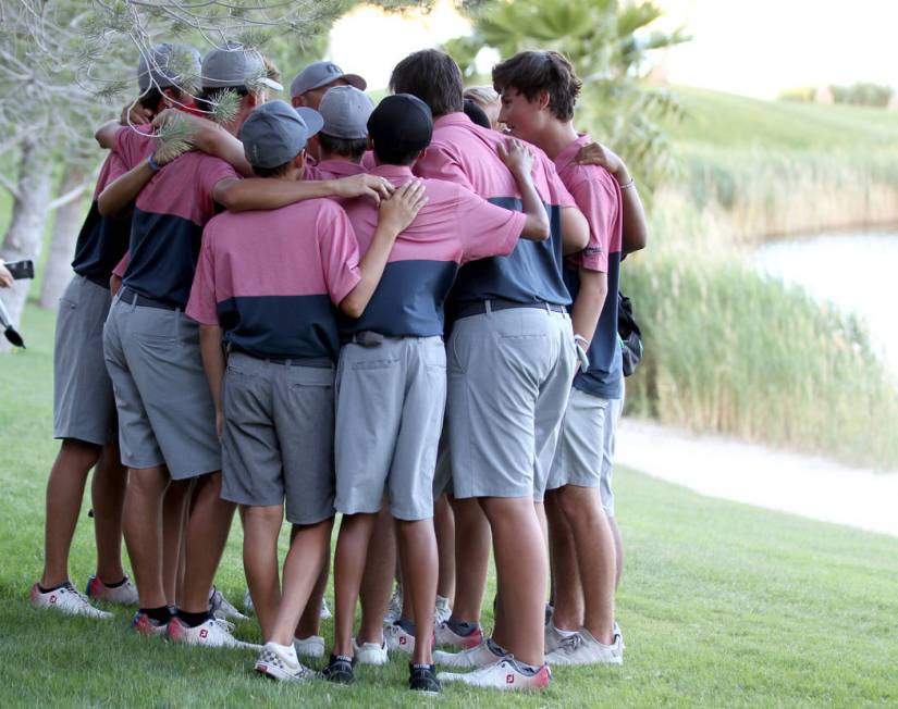 Members of the Coronado High School golf team huddle after winning the team Class 4A Nevada ...