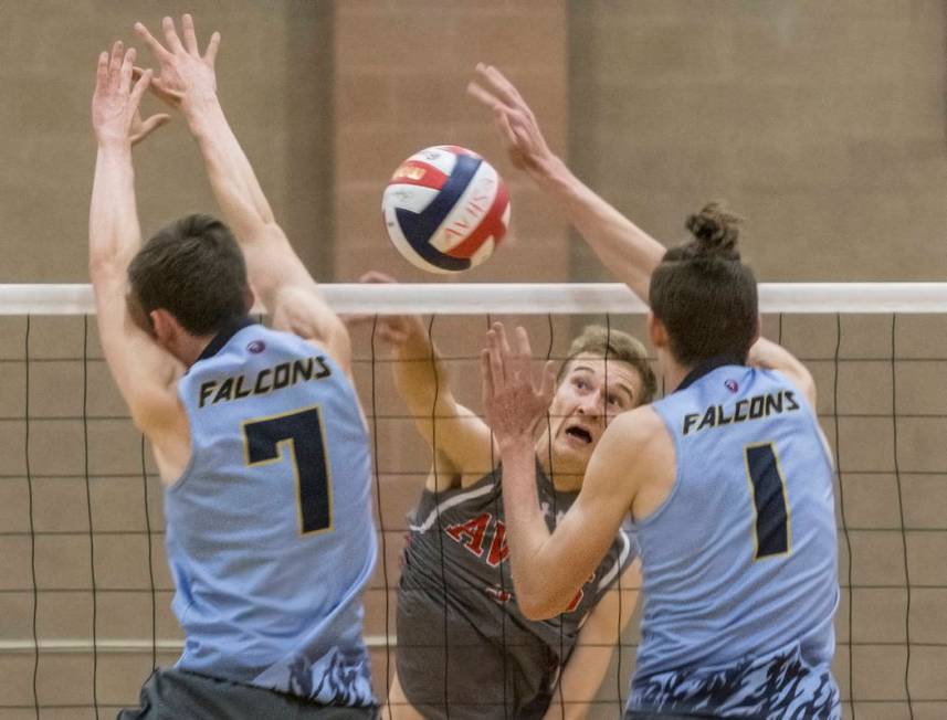 Arbor View senior Jake Reid (3) makes a kill past Foothill’s Dylan Meuller (1) and Cad ...