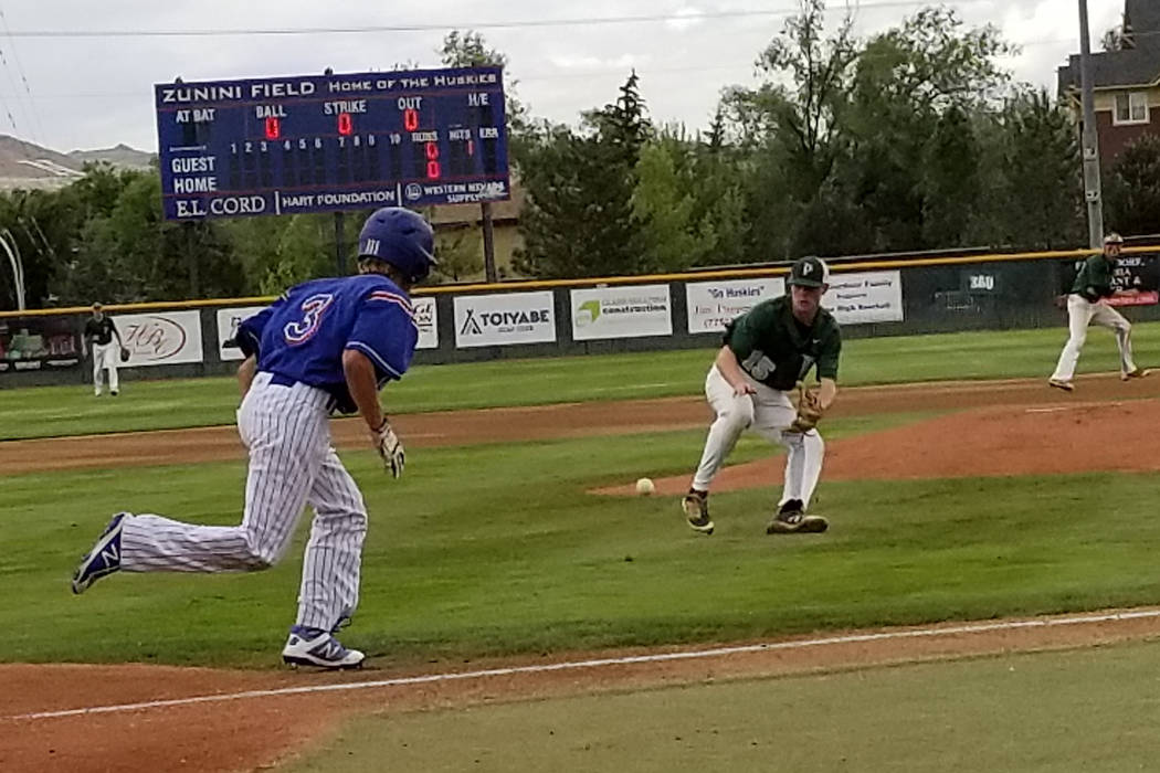 Palo Verde’s Bryce Robison fields a bunt as Reno’s Garrett Damico runs to first ...