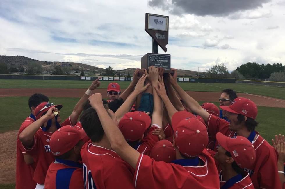 The Indian Springs baseball team celebrates winning the Class 1A state title after a 12-2 vi ...