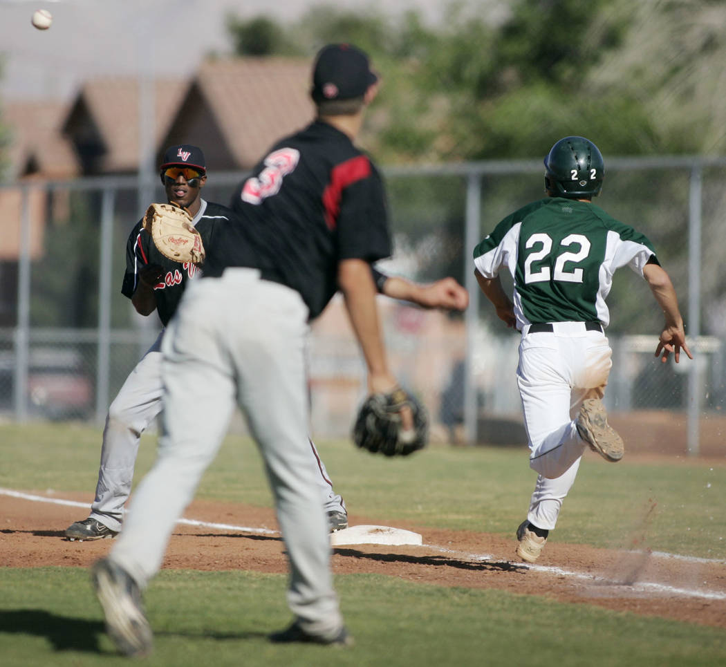 Las Vegas High School baseball player Bryan Harper throws to first baseman Marvin Campbell f ...