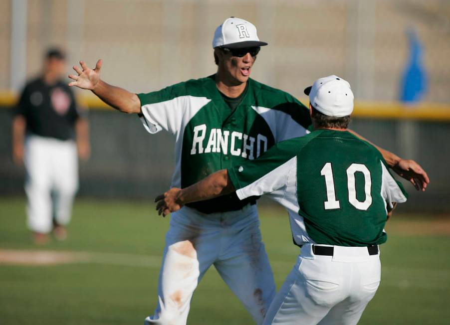 Rancho relief pitcher Zak Qualls celebrates with teammate P.J. Matha, #10, after getting a s ...