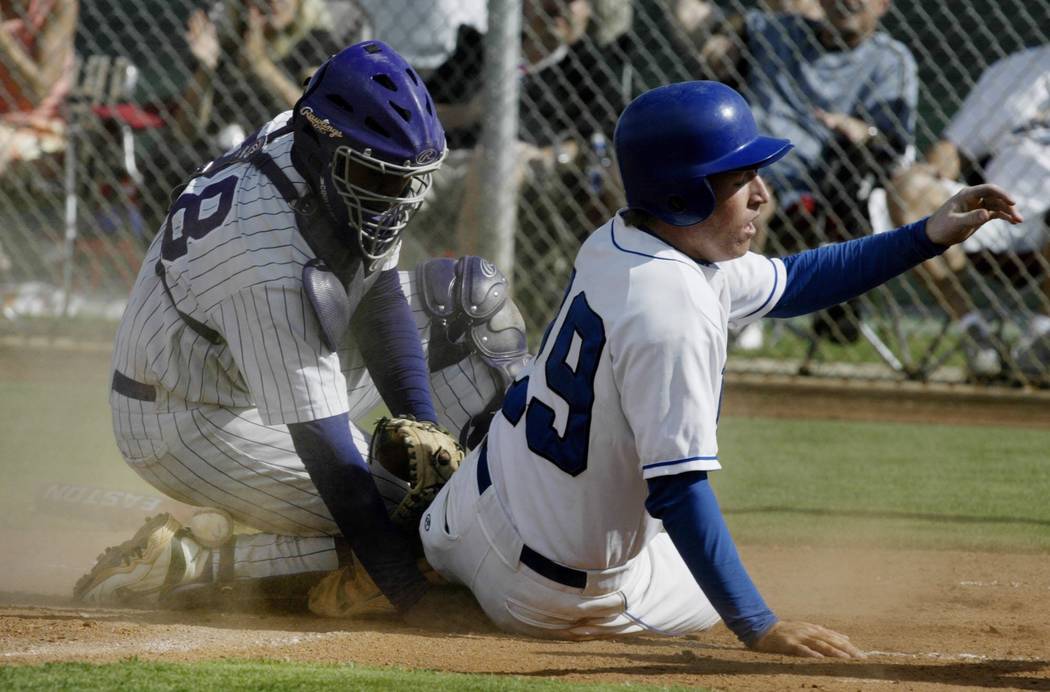 Durango catcher Mike McDade #28 searches for the ball under Sierra Vista baserunner Drew Lea ...